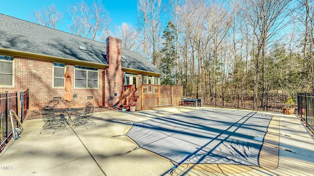 exterior space featuring a wooden deck and a patio area