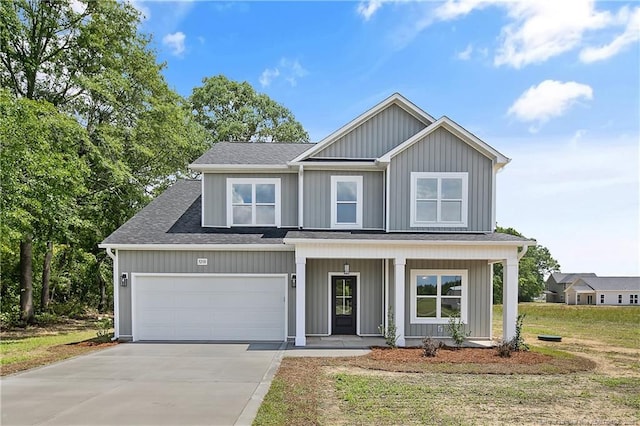 5210 Maxwell Rd, Stedman, NC 28391 - view of front of house with concrete driveway, a porch, roof with shingles, and a front lawn