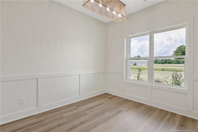 5210 Maxwell Rd, Stedman, NC 28391 - empty room with a decorative wall, light wood-type flooring, and a wainscoted wall