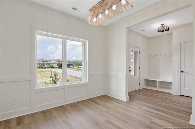 5210 Maxwell Rd, Stedman, NC 28391 - entrance foyer featuring light wood-style floors, a decorative wall, plenty of natural light, and a chandelier