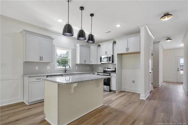 5210 Maxwell Rd, Stedman, NC 28391 - kitchen with appliances with stainless steel finishes, decorative backsplash, a sink, a center island, and recessed lighting