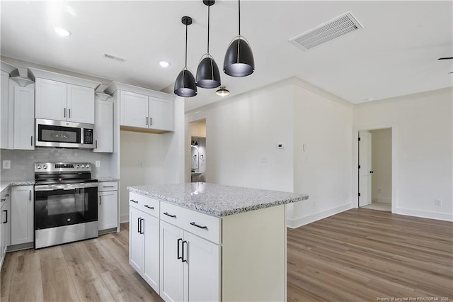 5210 Maxwell Rd, Stedman, NC 28391 - kitchen featuring stainless steel appliances, light wood finished floors, backsplash, pendant lighting, and recessed lighting