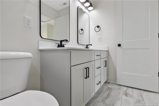 5210 Maxwell Rd, Stedman, NC 28391 - bathroom with marble finish floors, toilet, and double vanity