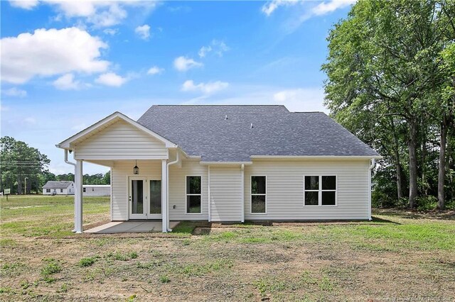 5210 Maxwell Rd, Stedman, NC 28391 - back of property featuring french doors, a yard, and roof with shingles