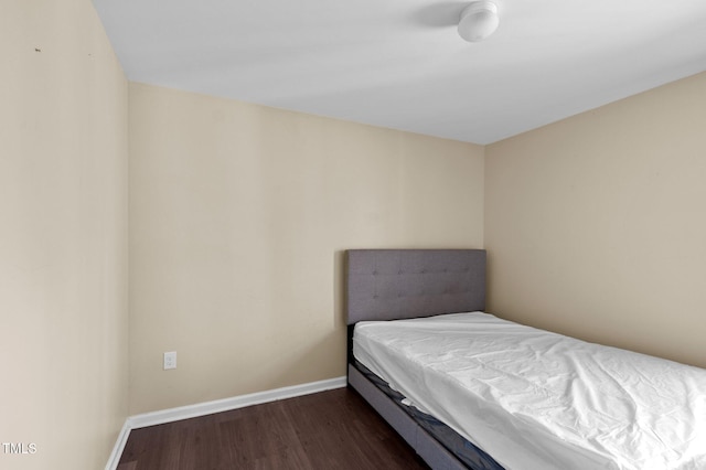 bedroom with dark hardwood / wood-style floors