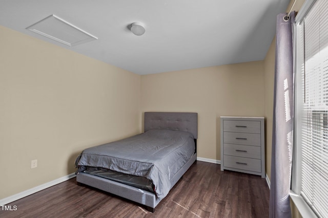 bedroom with dark hardwood / wood-style flooring