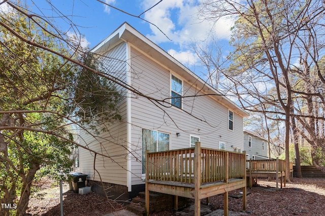 back of house featuring a wooden deck