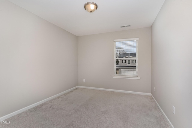 unfurnished room featuring visible vents, baseboards, and light carpet