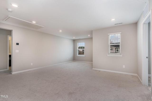 empty room with baseboards, visible vents, attic access, recessed lighting, and light carpet