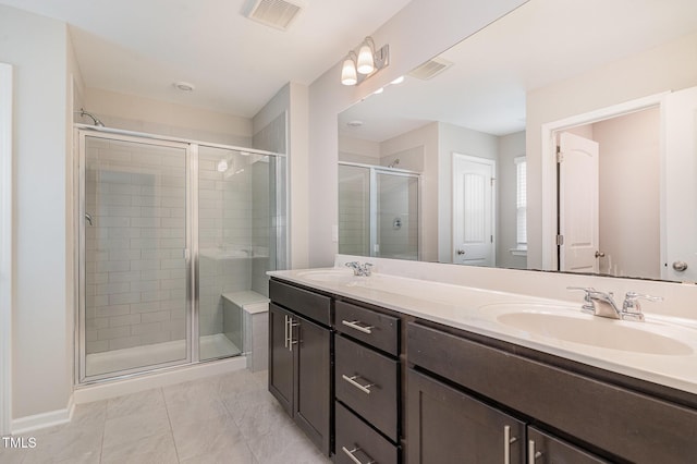 bathroom with a shower stall, visible vents, and a sink