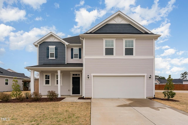 view of front facade featuring fence, driveway, a porch, an attached garage, and a front lawn