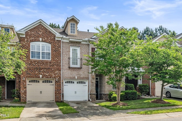 view of front of property with driveway, a garage, brick siding, and a shingled roof