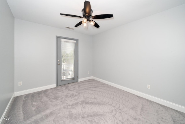 carpeted empty room with baseboards and ceiling fan