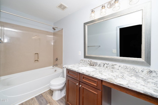 full bathroom with wood finished floors, toilet, vanity, and shower / bathtub combination