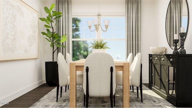 dining space with hardwood / wood-style flooring and a chandelier