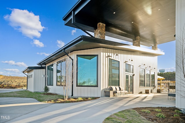 view of property exterior with a patio area