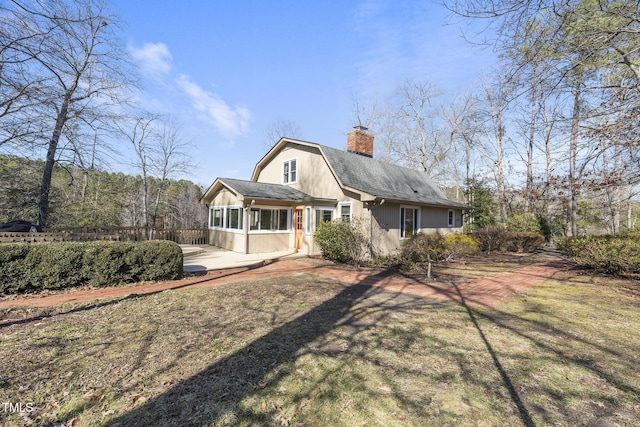 back of house featuring a yard and a patio