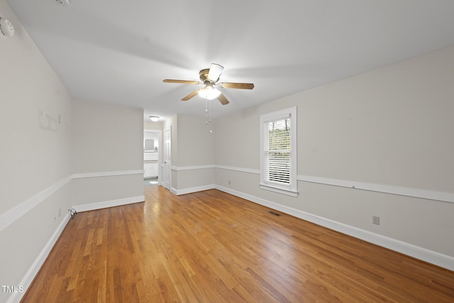 spare room featuring ceiling fan and light hardwood / wood-style flooring