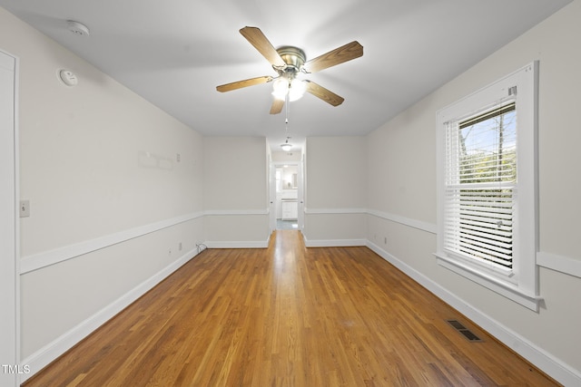 unfurnished room with wood-type flooring and ceiling fan