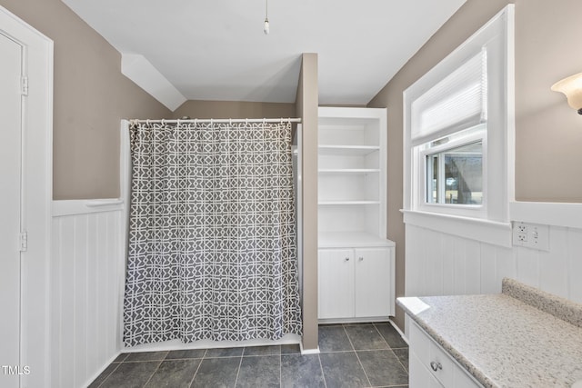 bathroom featuring vanity and a shower with shower curtain