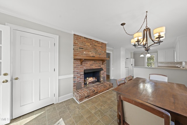 unfurnished dining area featuring crown molding, an inviting chandelier, and a fireplace