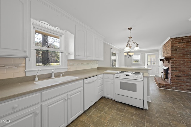 kitchen featuring pendant lighting, sink, white cabinets, kitchen peninsula, and white appliances