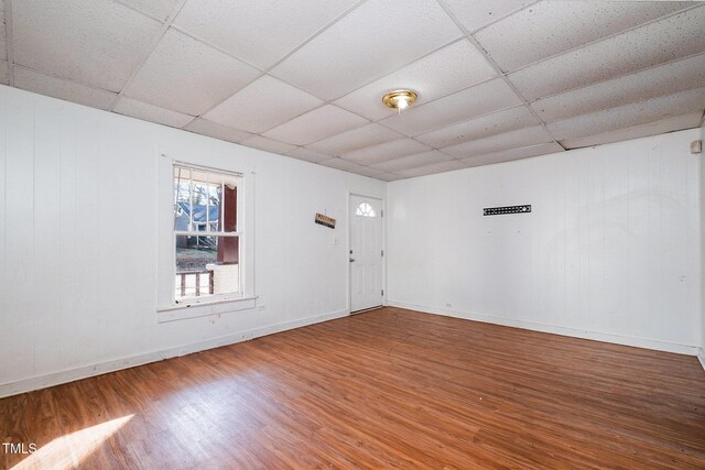 foyer entrance with wood-type flooring and a paneled ceiling