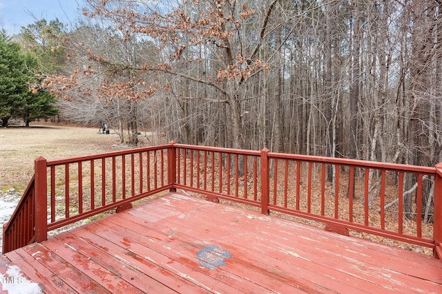 wooden deck featuring a lawn