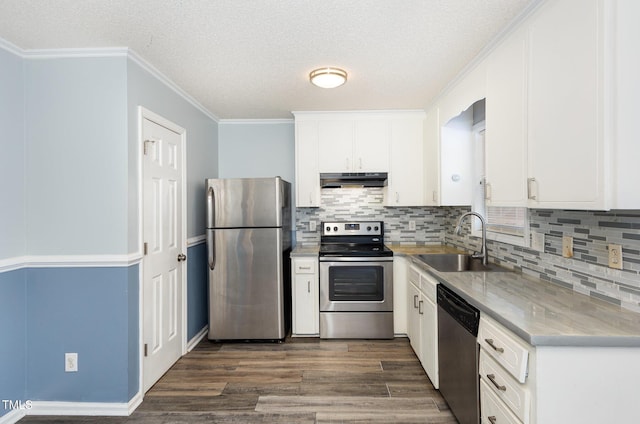 kitchen featuring sink, backsplash, stainless steel appliances, and white cabinets