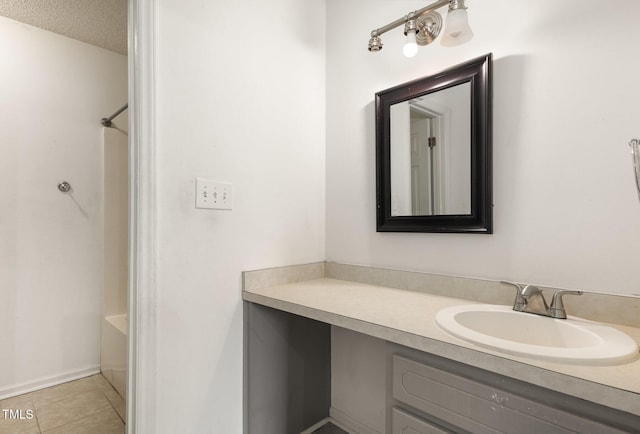 bathroom featuring vanity, tile patterned flooring, and a textured ceiling