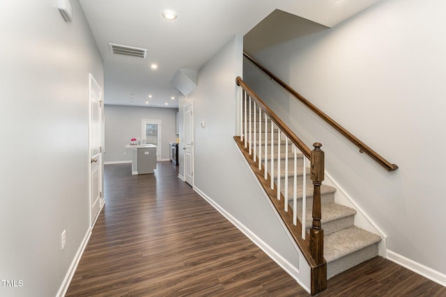 stairway featuring wood-type flooring