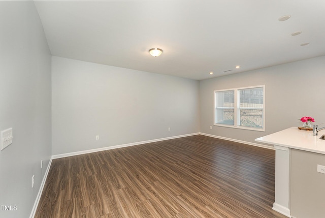 unfurnished room with dark wood-type flooring