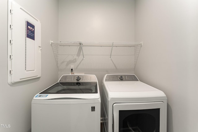 laundry area featuring washing machine and clothes dryer and electric panel