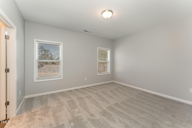 unfurnished room featuring light colored carpet