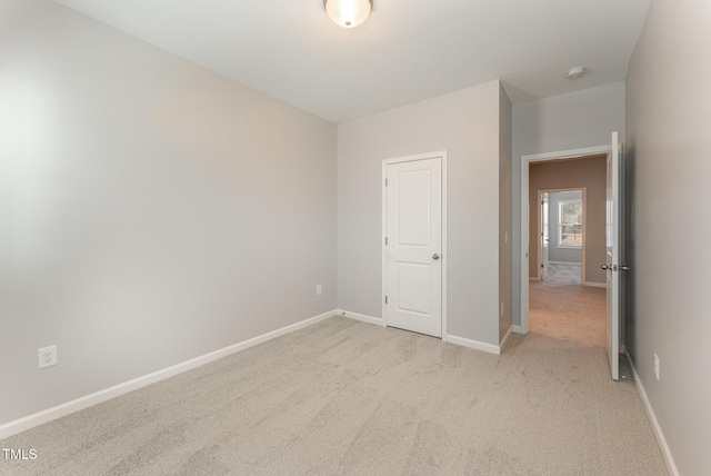 unfurnished bedroom featuring light carpet