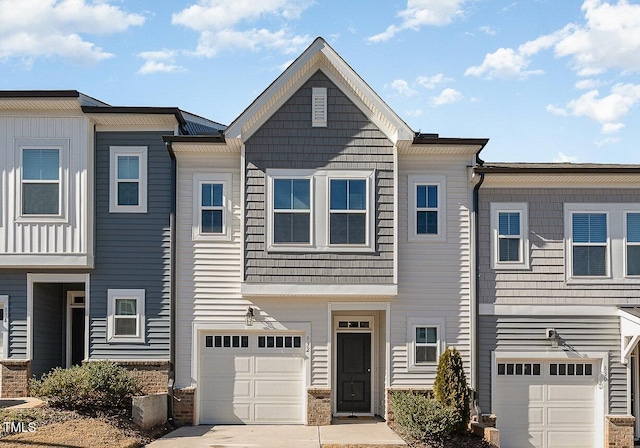 view of property featuring a garage and driveway