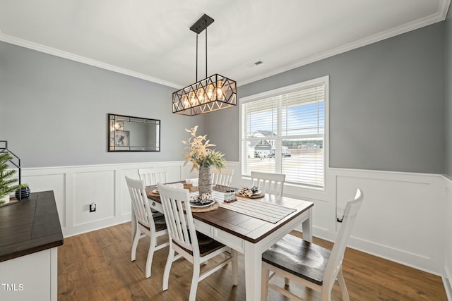 dining room featuring ornamental molding and hardwood / wood-style floors