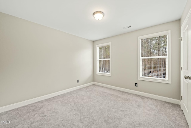 empty room featuring light carpet