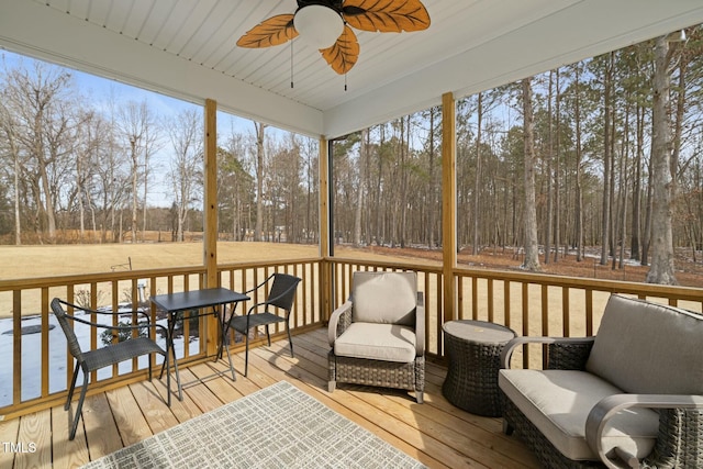 sunroom featuring ceiling fan