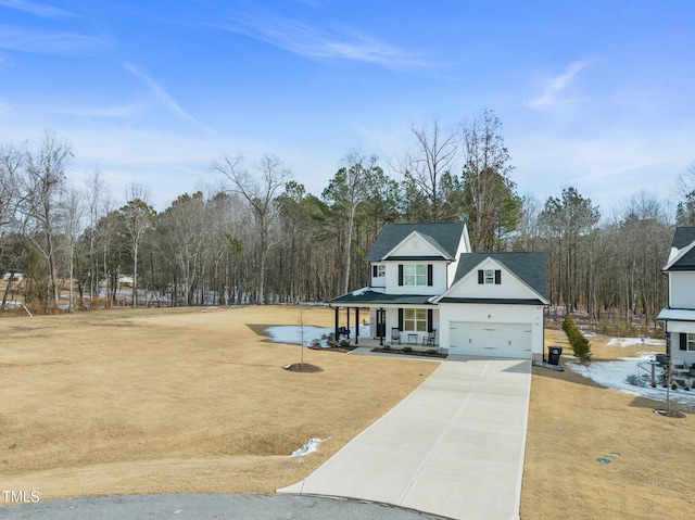 view of front of home featuring a garage and a porch