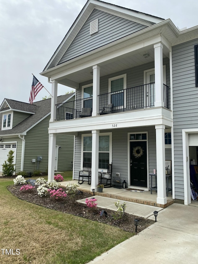 greek revival inspired property with a porch and a balcony