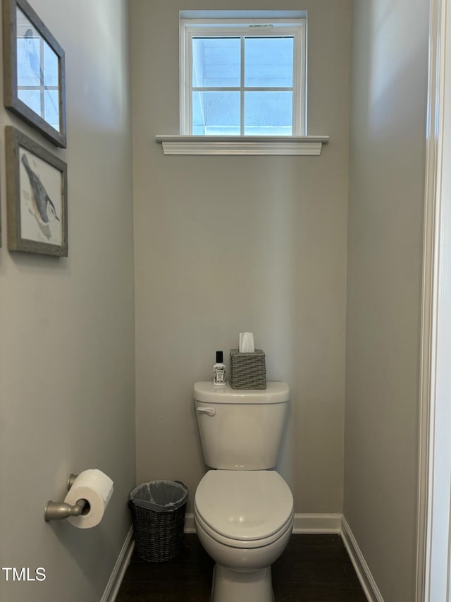 bathroom featuring hardwood / wood-style flooring and toilet