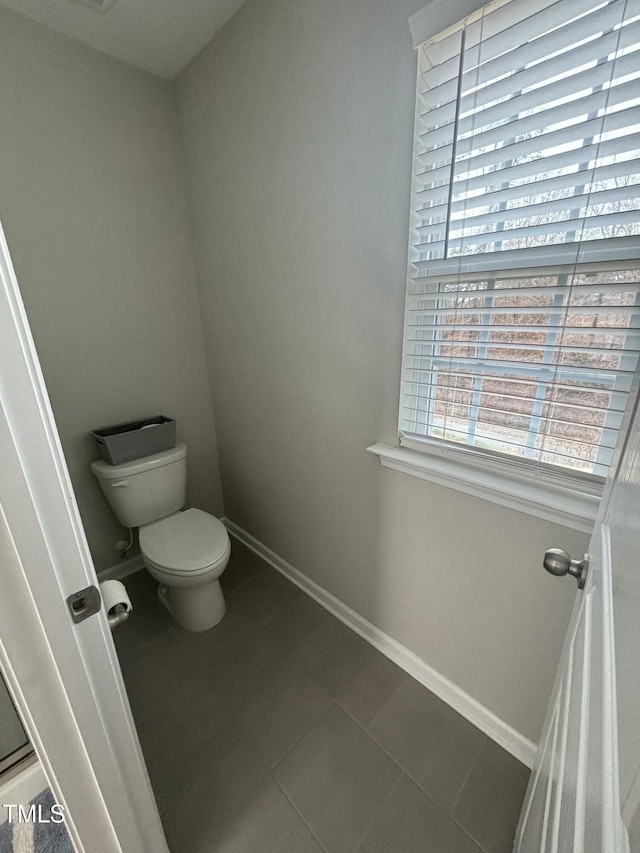 bathroom featuring tile patterned flooring and toilet