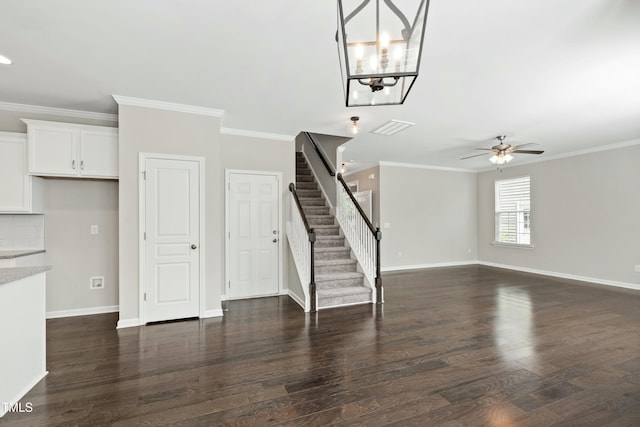 unfurnished living room with visible vents, ornamental molding, and ceiling fan