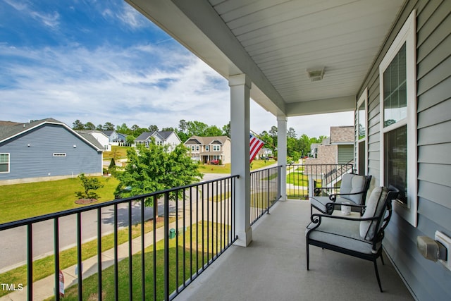 balcony featuring covered porch and a residential view