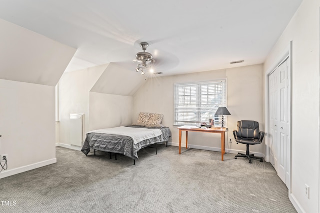 bedroom with a ceiling fan, vaulted ceiling, carpet, and baseboards