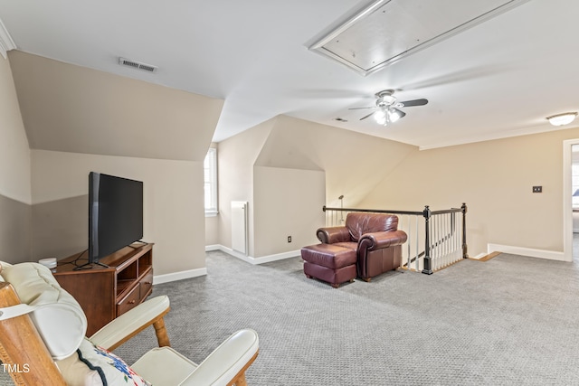 sitting room featuring visible vents, baseboards, attic access, vaulted ceiling, and carpet flooring