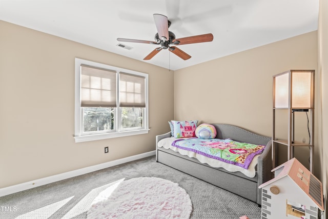 carpeted bedroom with a ceiling fan, baseboards, and visible vents