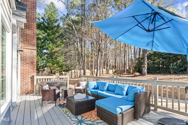 wooden deck with fence and an outdoor hangout area