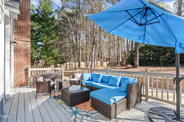 wooden terrace featuring fence and an outdoor hangout area